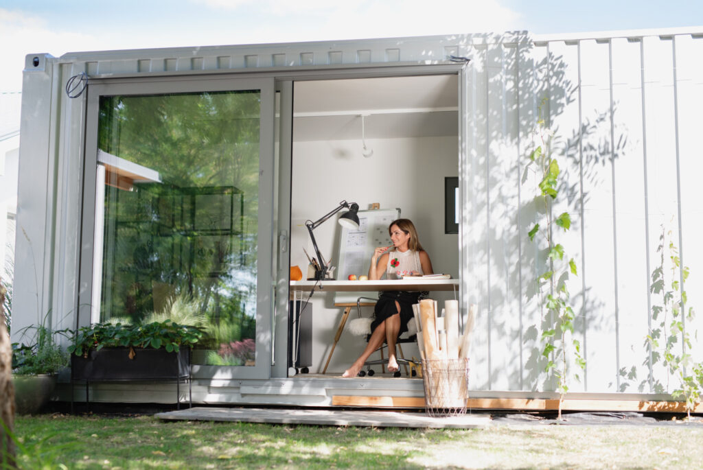 Lady working in her shipping container garden office