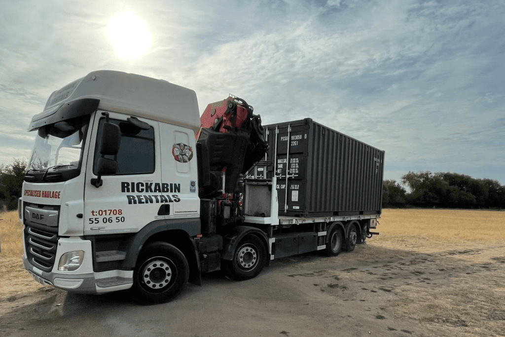 HIAB lorry delivering a container at a farm